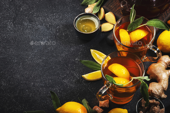 Healing black herbal tea with ginger, honey, lemon and sage - Stock Photo - Images