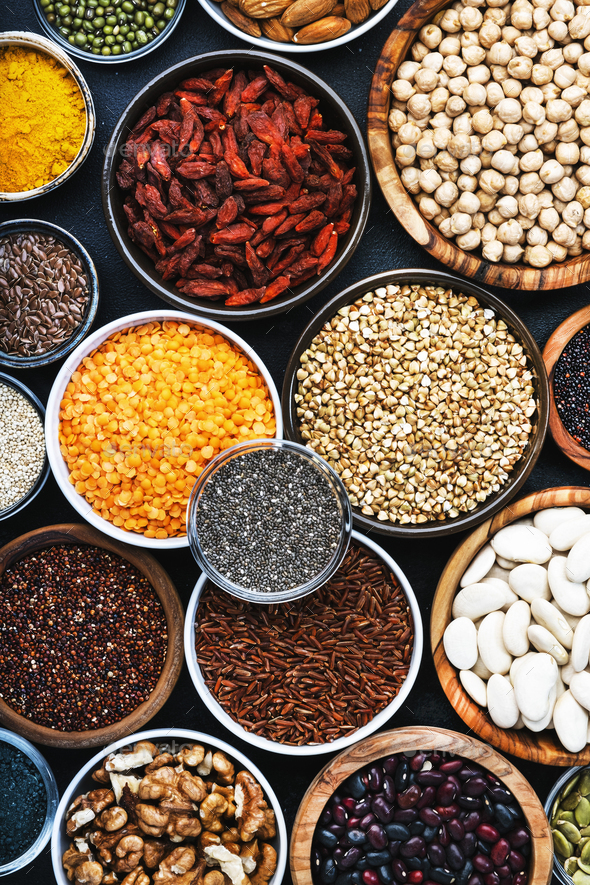 Superfoods, legumes, nuts, seeds and cereals selection in bowls - Stock Photo - Images