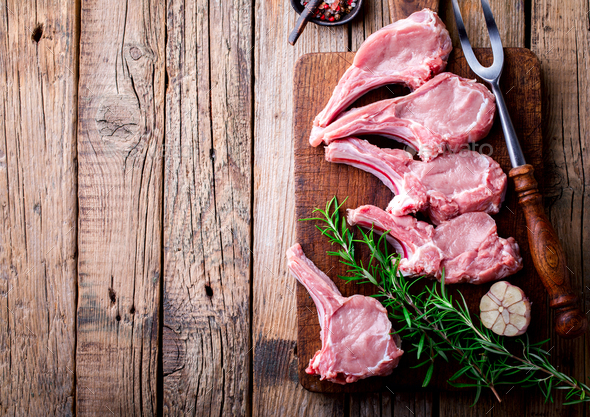 Raw fresh meat Veal rib Steak on bone and meat fork on a wooden vintage background . Food Concept - Stock Photo - Images