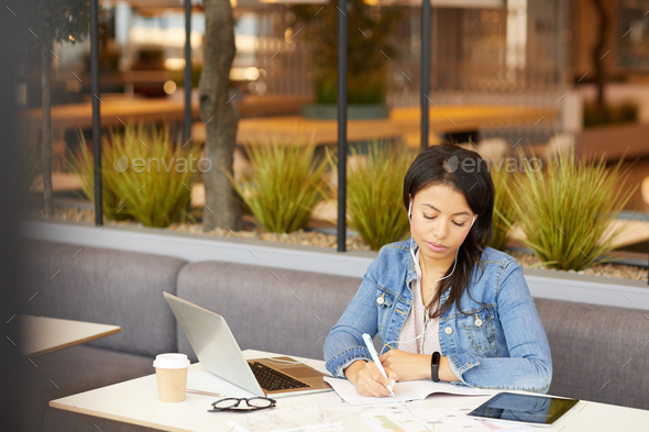 Young businesswoman working in cafe - Stock Photo - Images