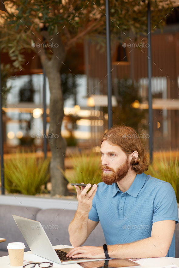 Businessman working with phone and laptop - Stock Photo - Images