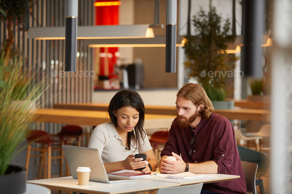 Teamwork during meeting in cafe - Stock Photo - Images
