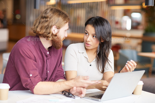 Business colleagues using laptop in work - Stock Photo - Images