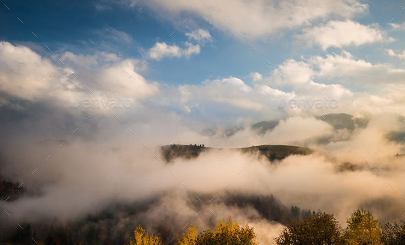 Foggy mountains under sky with clouds - Stock Photo - Images