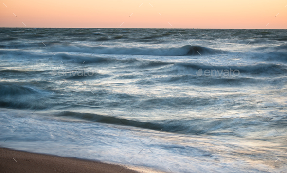 Fascinating sea waves splash along the sandy beach - Stock Photo - Images