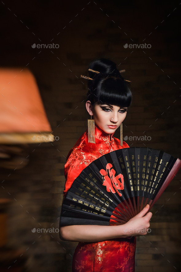 girl in a red Japanese silk dress qipao in a dark room Stock Photo by