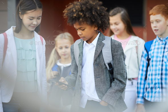 African schoolboy using the phone - Stock Photo - Images
