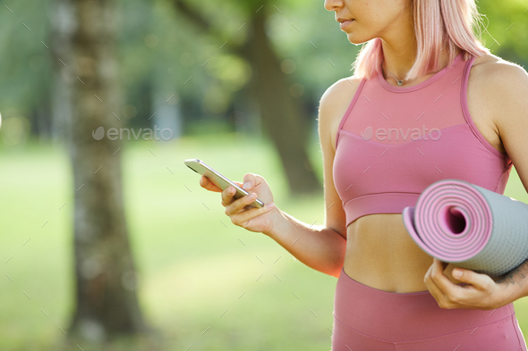 Sporty girl with mobile phone - Stock Photo - Images