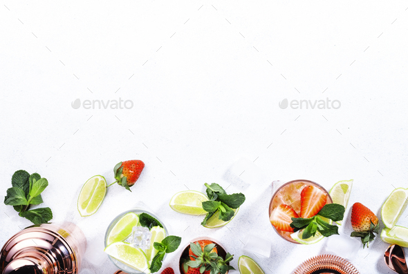 Fresh Mojito cocktail set with lime, mint, strawberry and ice in glass - Stock Photo - Images