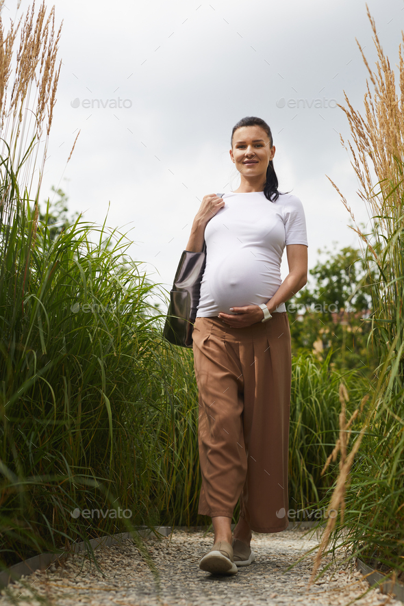 Happy pregnant woman in nature - Stock Photo - Images