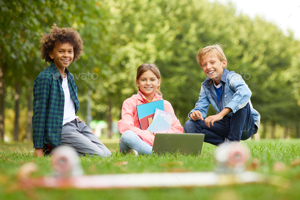 Group of friends sitting outdoors - Stock Photo - Images