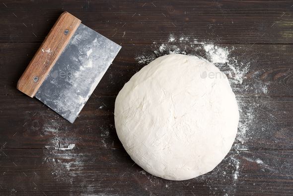 Freshly prepared yeast dough for health homemade bread on a gark brown wooden background - Stock Photo - Images