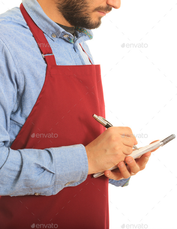 Waiter with red apron writes an order standing on white background - Stock Photo - Images