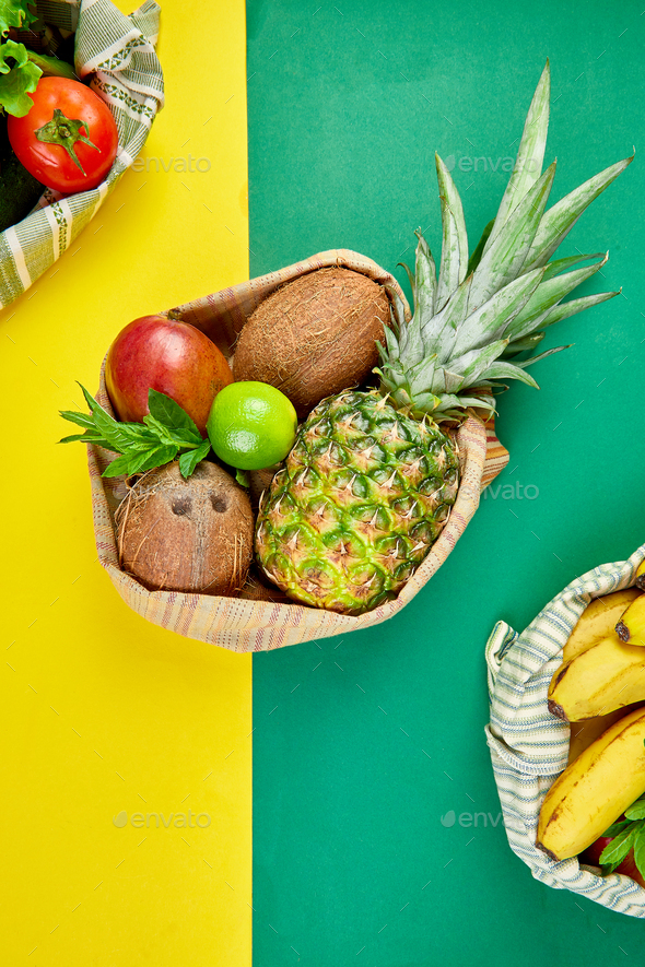 Eco shopping bags with organic fruits and vegetable on yellow background. - Stock Photo - Images