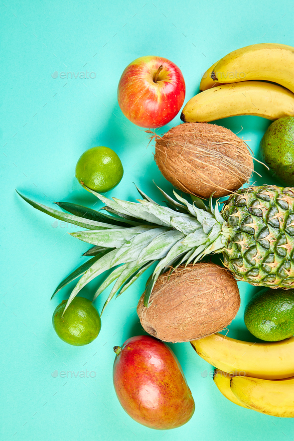 Flat lay of exotic fruits on blue background. - Stock Photo - Images