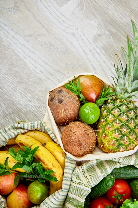 Fresh vegetables and fruits in eco cotton bags on table in the kitchen. - Stock Photo - Images
