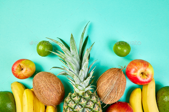 Flat lay of exotic fruits on blue background. - Stock Photo - Images