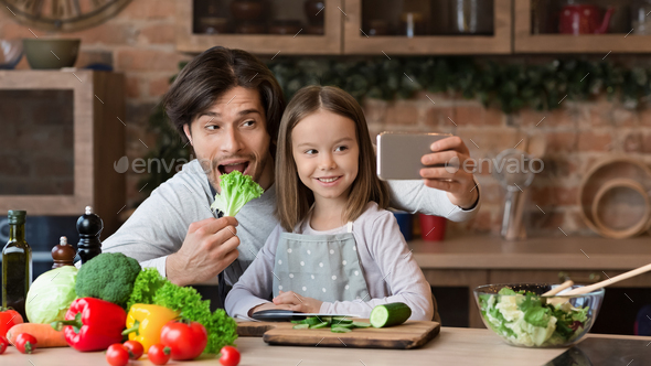 Joyful Dad Taking Selfie On Smartphone With Little Daughter In Kitchen - Stock Photo - Images