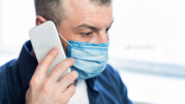 Man Talking On Phone Wearing Protective Medical Mask At Home - Stock Photo - Images