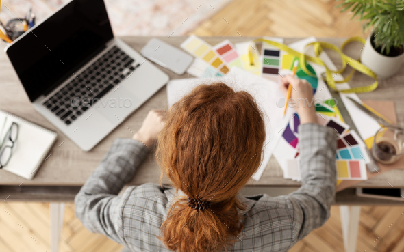 Young female fashion stylist working at home - Stock Photo - Images