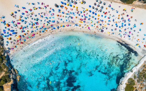 Aerial view of sandy beach with colorful umbrellas, people - Stock Photo - Images