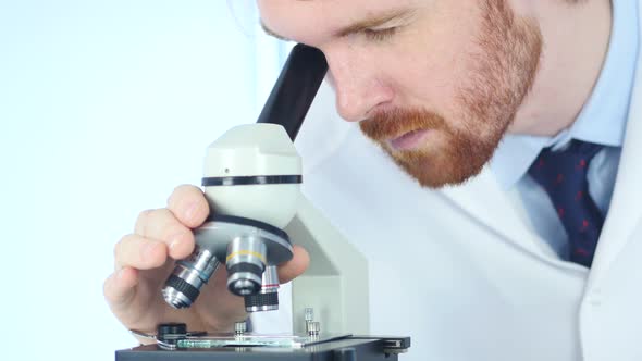 Doing Scientific Researcher using Microscope in Laboratory alt