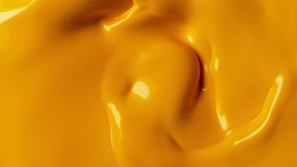 Super Slow Motion Shot of Swirling Yellow Fluid Background at 1000Fps alt