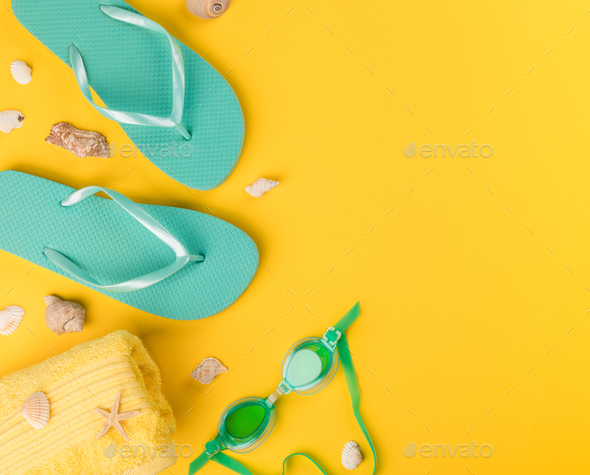 Beach accessories on yellow background.Summer vacation concept.Travel mood to the sea.