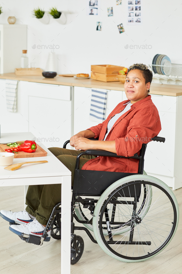 Disabled woman in domestic kitchen - Stock Photo - Images