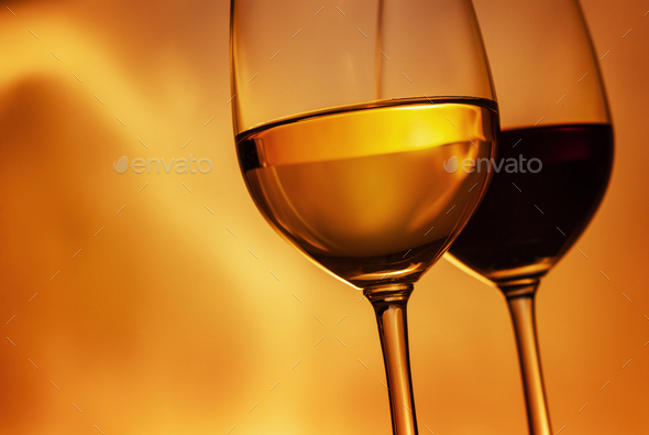 Tilted angle wineglasses with red and white wine - Stock Photo - Images