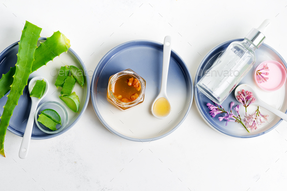 Natural ingredients for making cosmetic homemade lotion or essential oil on a light grey background - Stock Photo - Images