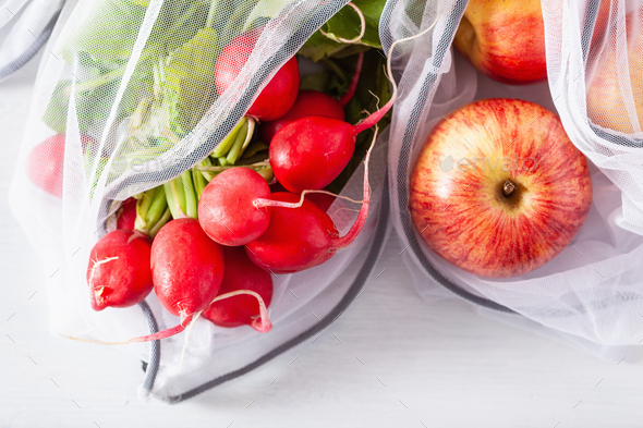 fruits and vegetables radish apple in reusable mesh nylon bag, plastic free zero waste concept