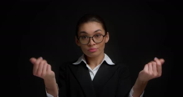 Business Woman Shows a Money Gesture with Her Fingers