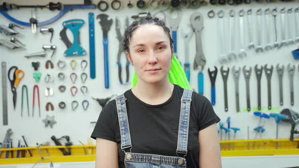 Female Technician Near Tool Board