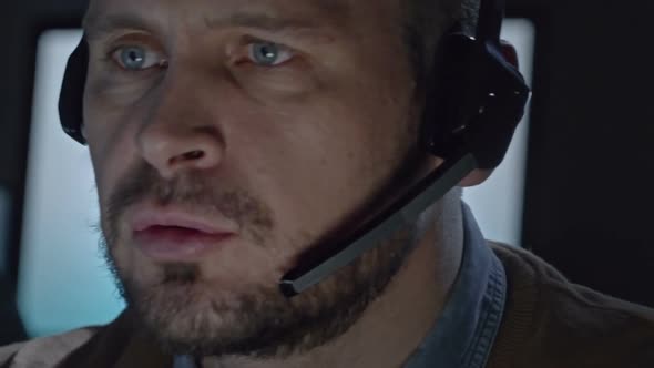 Serious Man Talking into Headset alt