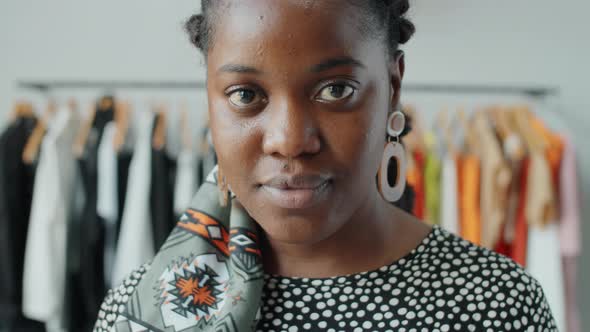 Portrait of Young Beautiful Afro Woman in Clothes Shop alt