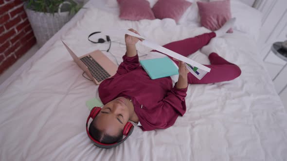 Top View of Exhausted Angry Young Woman Analyzing Business Graphs Throwing Away Paperwork Sighing alt