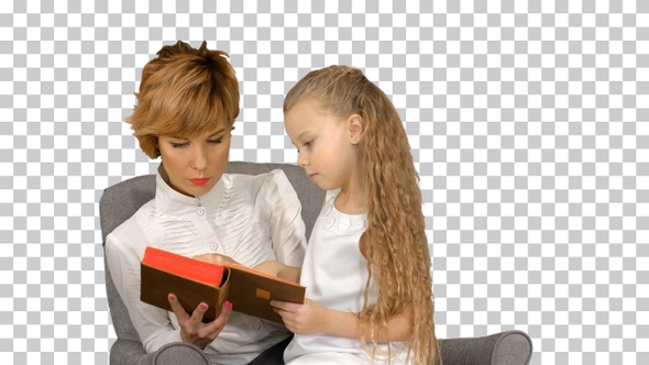 Mother and daughter reading book on the couch, Alpha Channel