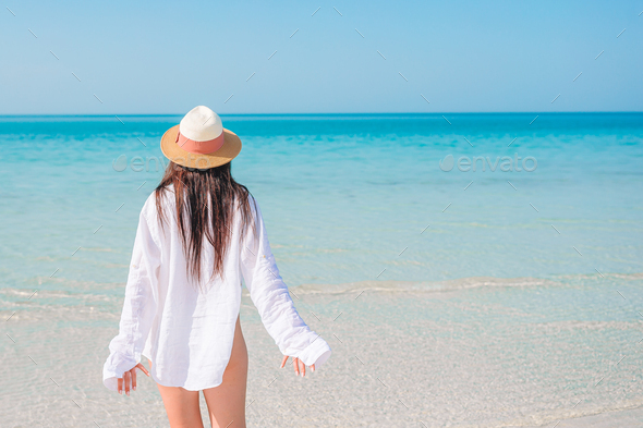 Woman Laying On The Beach Enjoying Summer Holidays Looking At The Sea