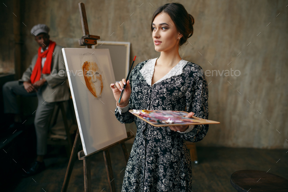 Female portrait painter and male model in studio - Stock Photo - Images