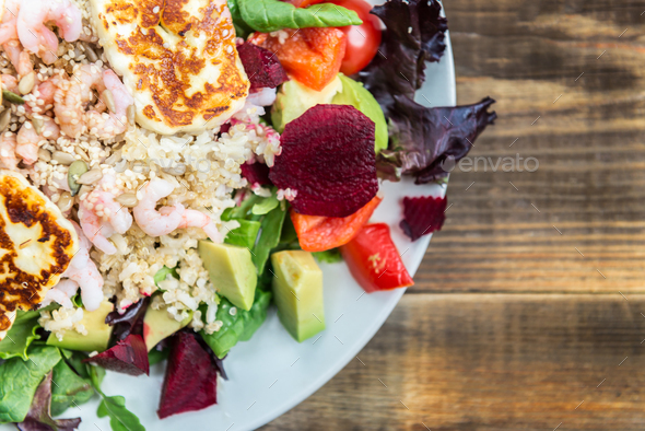 Warm Salad from Brown Rice, Quinoa, Prawns, Halloumi and Veg - Stock Photo - Images
