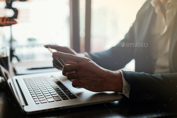 freelance blogger browsing phone indoors on work day - Stock Photo - Images