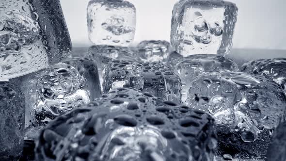 Camera Moving Away From Melting Ice Cubes Covered with Water Drops alt