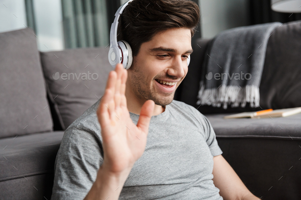 Portrait of an attractive smiling young bearded man - Stock Photo - Images