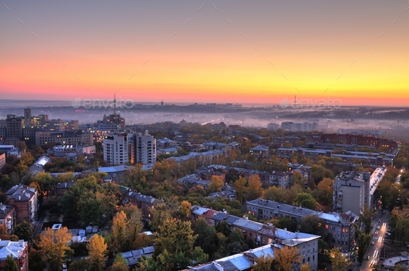Aerial view of sun rises over summer European city - Stock Photo - Images