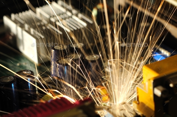 Burning sparks fly from a circuit chip - Stock Photo - Images