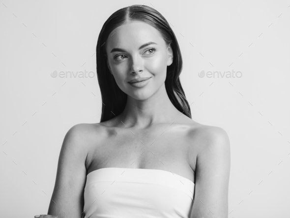 Natural beauty woman with heands touching face long brunette hair beautiful neck and shoulders. - Stock Photo - Images