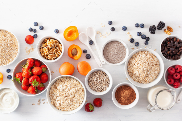 fruits for breakfast. Oatmeal flakes and steel cut, barley, walnut, chia, apricot, strawberry - Stock Photo - Images