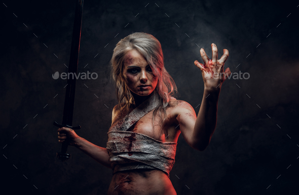 Naked Fantasy woman warrior wearing rag cloth stained with blood and mud in the heat of battle - Stock Photo - Images
