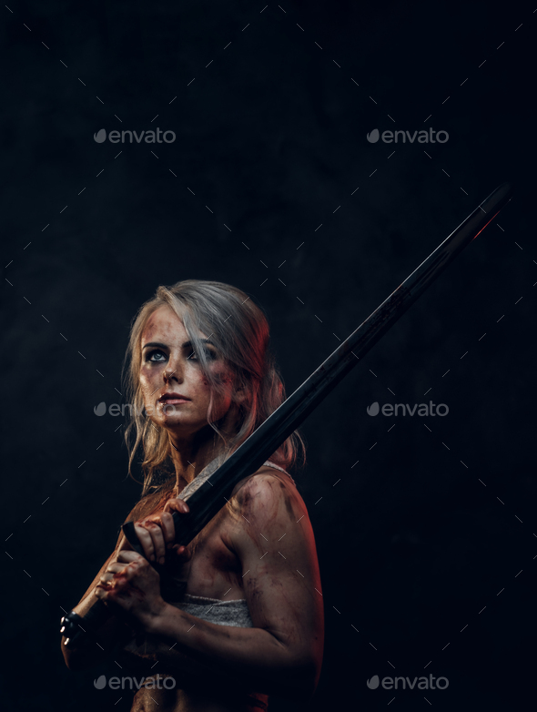 Naked fantasy woman warrior wearing rag cloth stained with blood and mud - Stock Photo - Images